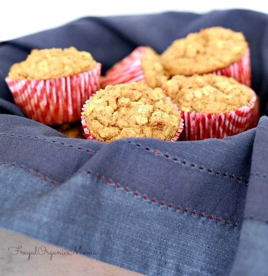 Freshly baked healthy banana muffins with no refined sugar, topped with walnuts